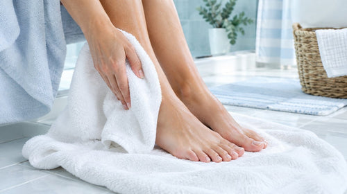 Drying feet with towel